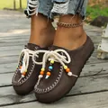 Detail view of brown suede ethnic loafers with colorful beads and white stitching - 36 / Coffee
