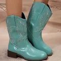 Detail of turquoise mid-calf cowboy boots with white embroidery and chunky heels. - 36 / Sky Blue