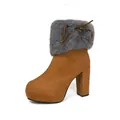 Detailed view of brown suede winter boots with grey faux fur collar and chunky heels. - 34 / Brown