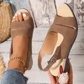 Close-up detail of brown peep-toe wedge sandals featuring a comfortable ankle strap buckle - Brown