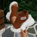 Detailed view of women's brown knit peep-toe wedge platform sandals with thick white soles - 36 / Brown