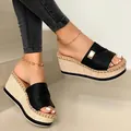 Elegant women's black wedge sandals featuring a straw platform and gold buckle detail - 35 / Black