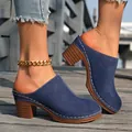 Navy blue closed-toe chunky heel mules with white stitching details on a wooden deck - 36 / Blue