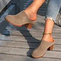 Close-up of stylish tan closed-toe mules with chunky wood-effect heels and white stitching - 36 / Khaki