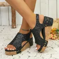 Detailed shot of black glitter wedge sandals with cork platform and gold rivets on feet. - 35 / Peep Toe Wedge Sandals (043) / Sequin Black