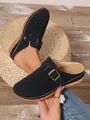 Close-up detail of black platform clogs featuring white decorative stitching and metal buckle - 36 / Black