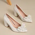 Elegant white tweed chunky heel pumps featuring a pearl-embellished bow and pointed toe - 35 / White