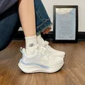 Detailed close-up view of white breathable running sneakers for women featuring a chunky cushioned sole - 35 / Blue