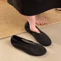 Detailed view of breathable black mesh flat shoes on foot for stylish commute - 35 / Black
