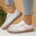 Close-up detail of retro women's German army trainers in pink and white leather - 36 / Pink