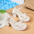 Elegant cream-colored platform sandals featuring chunky heels and stylish criss-cross straps - 35 / White