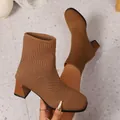Detailed macro shot of tan knitted sock boots with chunky block heels and ribbed cuffs. - 36 / Brown