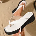 Close-up of white thick-soled thong sandals with square toe on beach sand background - 35 / White
