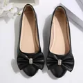 Elegant black pointed-toe flat shoes with rhinestone-decorated bow, slip-on style for women. - 36 / Black