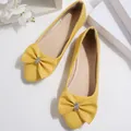 Elegant yellow pointed-toe flat shoes with rhinestone-studded bow detail and textured finish - Yellow