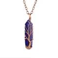 Close-up of handmade wire-wrapped Tree of Life pendant on blue crystal column. - Lapis Lazuli