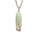 Detailed view showing handmade copper wire wrapped tree of life on green crystal - Green Aventurine