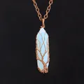 Close-up of vintage handmade wire-wrapped hexagonal crystal tree of life necklace - Opal