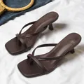 Elegant dark brown square toe thong sandals with kitten heels shown on white fabric - Dark Brown