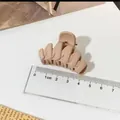 Professional medium matte nude hair claw clip shown with a ruler for size reference - Fishbone Style / Khaki