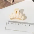 Classic matte cream-colored hair claw clip with ruler for size measurement reference. - Fishbone Style / White