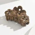 Elegant matte coffee brown hair claw clip featuring a stylish three-flower relief design - Hollow Flower / Light Coffee