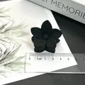 Matte black frosted flower hair claw clip displayed with a clear centimeter ruler. - Five-Petal Flower / Black