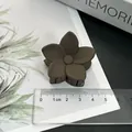 Matte brown flower hair claw clip displayed with a ruler showing its medium 4cm size. - Five-Petal Flower / Dark Coffee