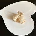 Elegant creamy matte bow-shaped hair claw clip for women on heart display tray - Bowtie / White