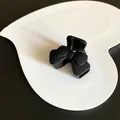 Elegant matte black hair claw clip featuring a classic bow design on a white heart tray - Bow Tie / Black