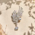 Close-up of silver-tone angel wing brooch with micro-pave zircons and pearl. - Silver Wing Brooch