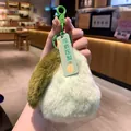 Close-up of a soft light green plush pear keychain with funny No Pressure Pear tag hanging - Pear Shaped Pendant / Green
