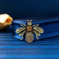 Vintage gold honey bee brooch with orange rhinestones displayed on a blue satin box - Antique Gold Coffee Bee (XD824005-2) / Antique Gold, Coffee
