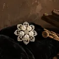 Close-up of elegant crystal pearl eight-petal flower brooch on black velvet backdrop - Vintage Hollow Pearl Floral Style (BH33)
