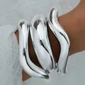 Brazalete abierto grueso e irregular en tono plateado con un efecto de metal líquido - Brazalete Abierto Ondulado de Metal Líquido Irregular Plateado (6579602HB) / Plateado