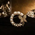 Elegant butterfly and pearl wreath brooch featuring sparkling crystal accents and gold finish - Ring Butterfly Pearl Style (BH08-Gold)