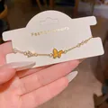 Elegant gold butterfly bracelet with pearls and shimmering zircons for women. - Yellow Enamel Butterfly Pendant Style