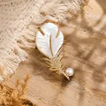 Close-up macro view of elegant feather brooch featuring white mother-of-pearl and crystals - White Mother of Pearl Rhinestone Feather