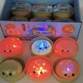 Close-up of glowing glitter bun squishy toys with LED lights in mystery display box - 8.5cm Gel LED Bun