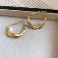 Elegant twisted gold hoop earrings with textured finish on fabric background - Twisted Patchwork Textured Hoop Style (52#) / Gold