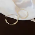 Elegant minimalist silver hoop earrings with a textured metal finish for a chic look - Three-Layer Twisted Hoop Earrings / Silver