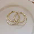 Elegant double-layered gold hoop earrings with textured inner ring and smooth outer ring. - Double Layer Design Hoop (85# 925 Sterling Silver Earring Post) / Gold