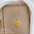 Detail view showing the mesh texture of a gold-plated titanium steel heart necklace - Hollow Heart Necklace / Gold