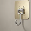 Large golden adhesive wall hook with 6.5x6.5cm brushed metal base for bathroom - Gold (Large)