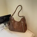 Large capacity brown leather hobo shoulder bag with stylish zipper tassels for autumn fashion - Caramel color