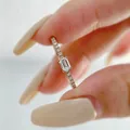 Elegant rose gold ring featuring an emerald-cut simulated diamond shown on hand - US Size 5 / Rose Gold