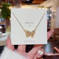 Elegante Halskette aus goldfarbenem Titanstahl mit funkelndem Zirkonia-Bogenanhänger. - Schleifenstil (X432) / 18K-Gold / Gold