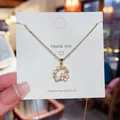 Elegante Halskette aus Titanstahl mit einem filigranen Anhänger in Form eines Blütenkranzes - Kirschblüten-Kranzdesign (X441) / 18K-Gold / Gold