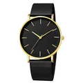 Detail view of a minimalist quartz watch with a black dial and gold-finished metal case - Gold Case Black Dial Black Band