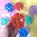 Jouet squishy mochi orange translucide avec texture bosselée pour soulager le stress - Balle Fidget Pierre Précieuse Rouge
